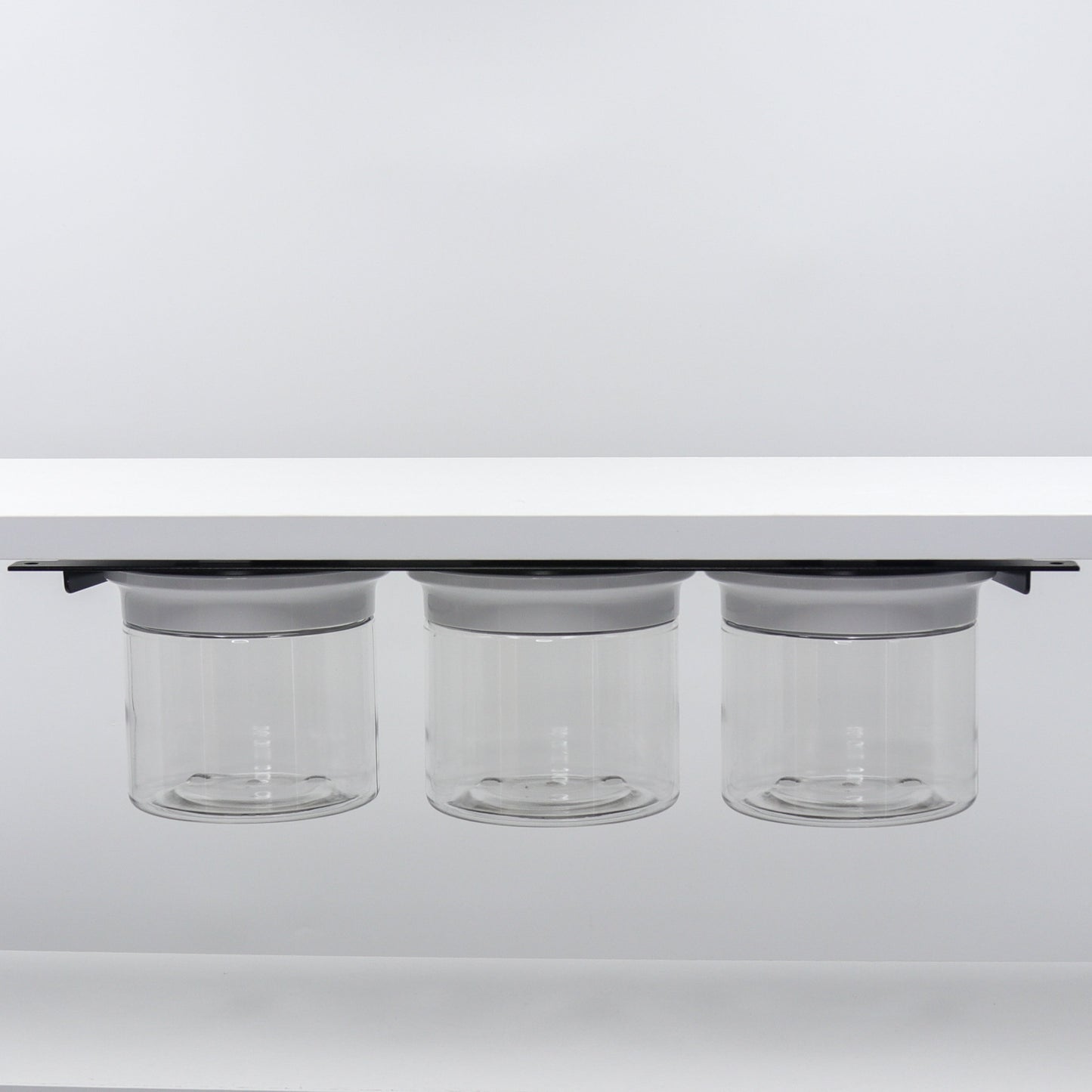 Under Sink/Under Shelf Organizer, Stainless POS featuring three jars with white lids mounted under shelf for efficient cabinet use.