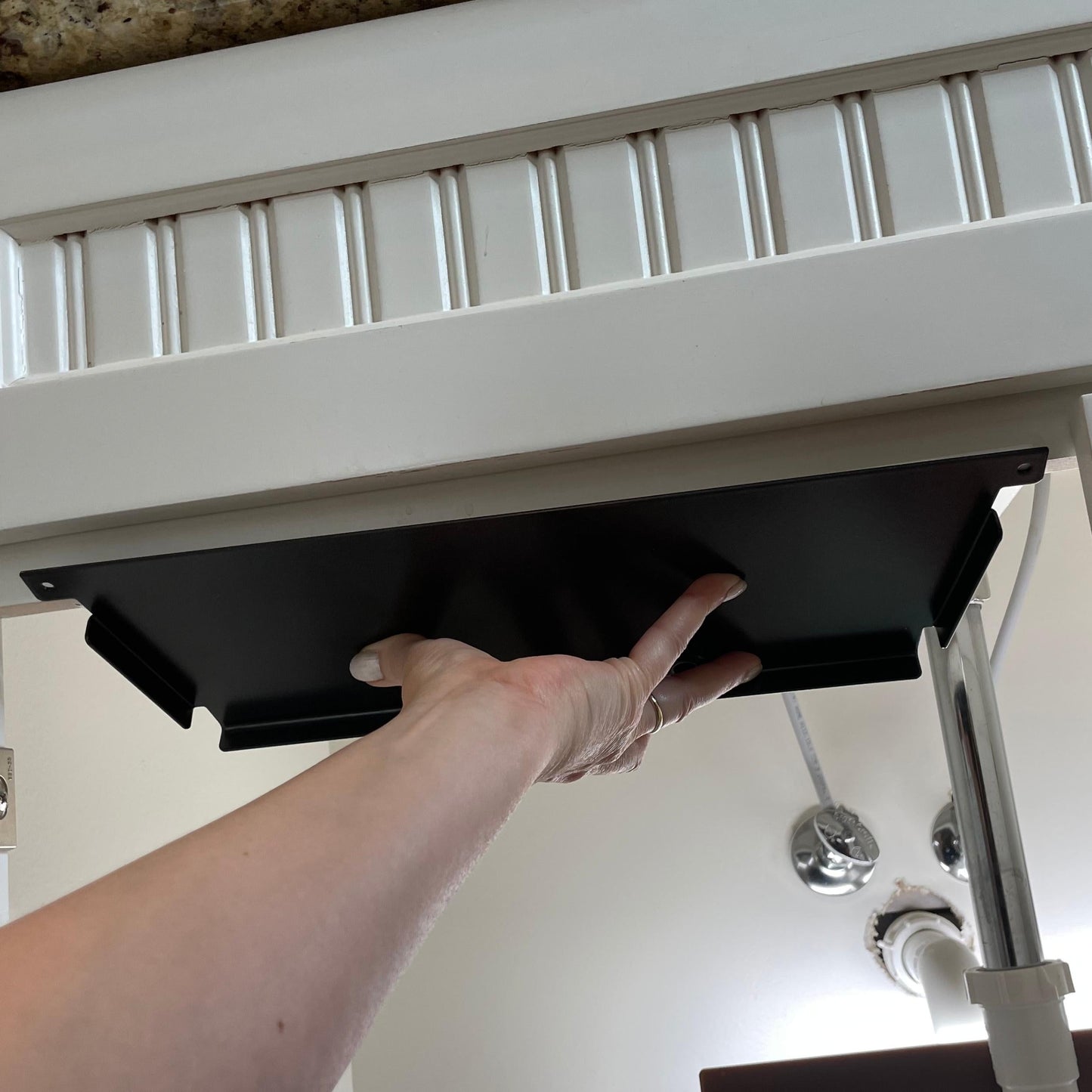 Under Sink/Under Shelf Organizer, Stainless POS mounting plate being installed under sink cabinet to support storage jars efficiently.