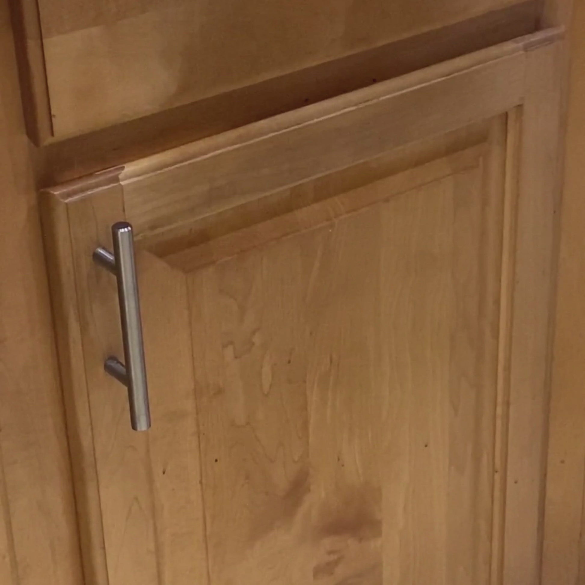 Closed wooden cabinet door concealing under sink area, suitable for installing Laundry Containers Organizer for hidden, efficient laundry supply storage.