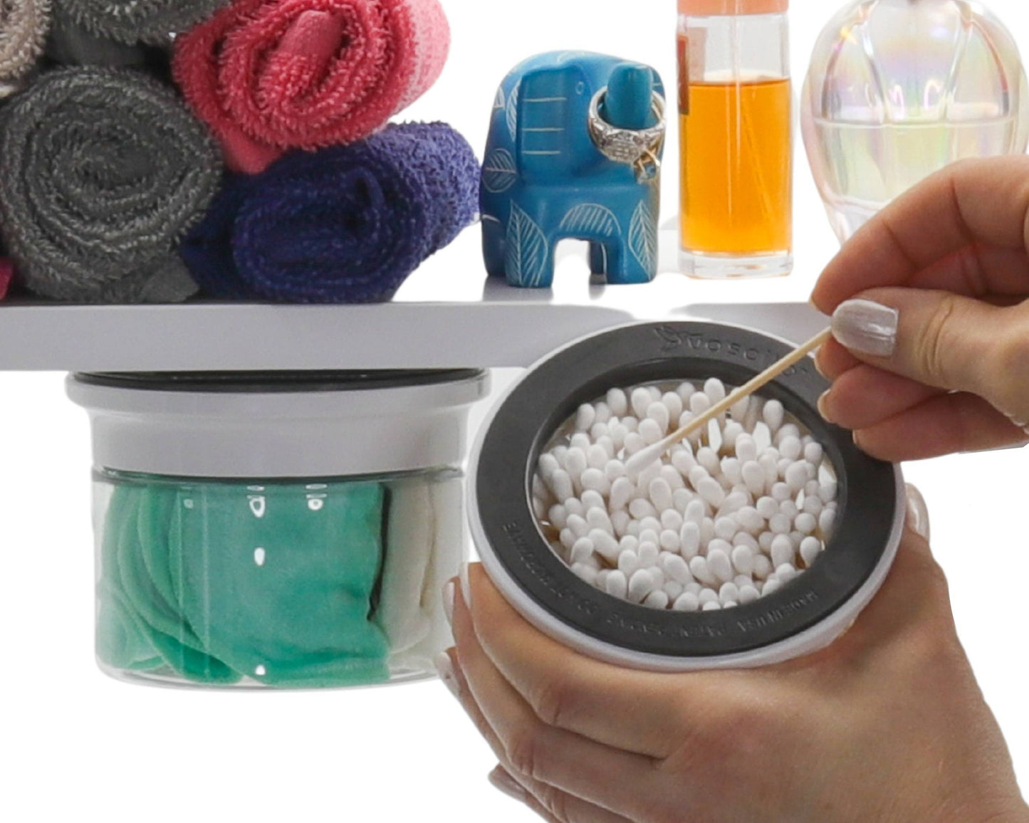 White-lidded under-shelf Cotton Ball Holder & Q Tip Organizer storing green cloths and Q tips, surrounded by colorful bathroom items.