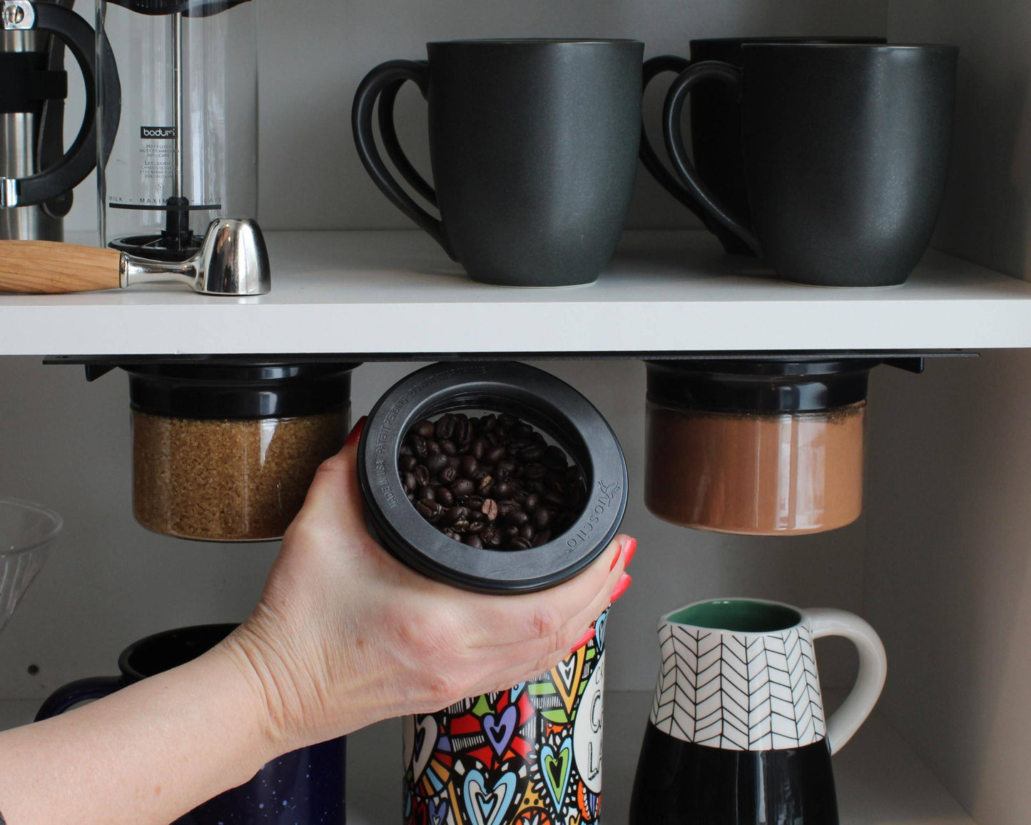 Under cabinet storage organizer with airtight jars holding coffee beans and spices, ideal for space-saving kitchen organization and clutter-free counters.
