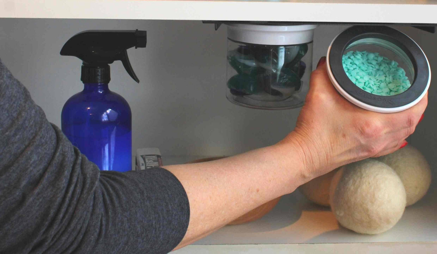 User accessing airtight jar from Laundry Containers Organizer, ideal for organizing laundry supplies under sink with smell-proof, space-saving containers.