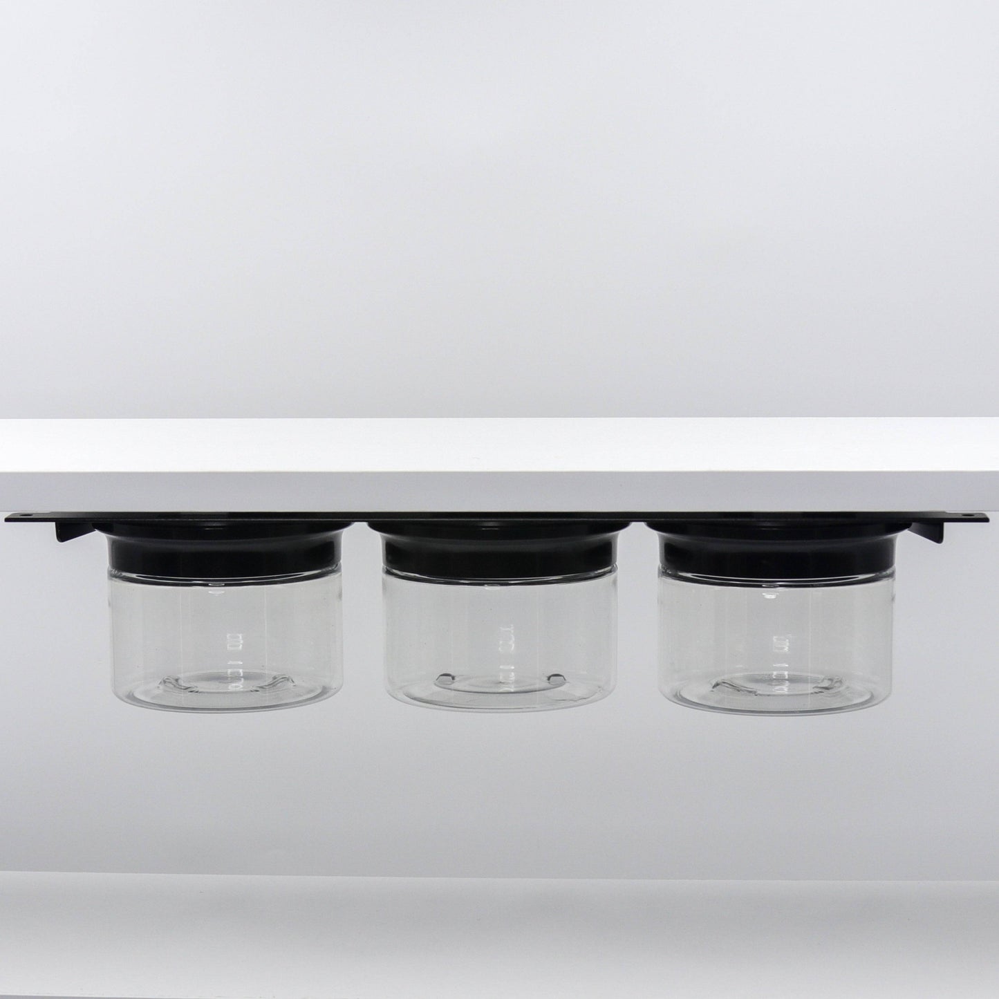 Under shelf organizer with three black-lid jars for bathroom storage. Smell proof and space-saving design for home or RV.