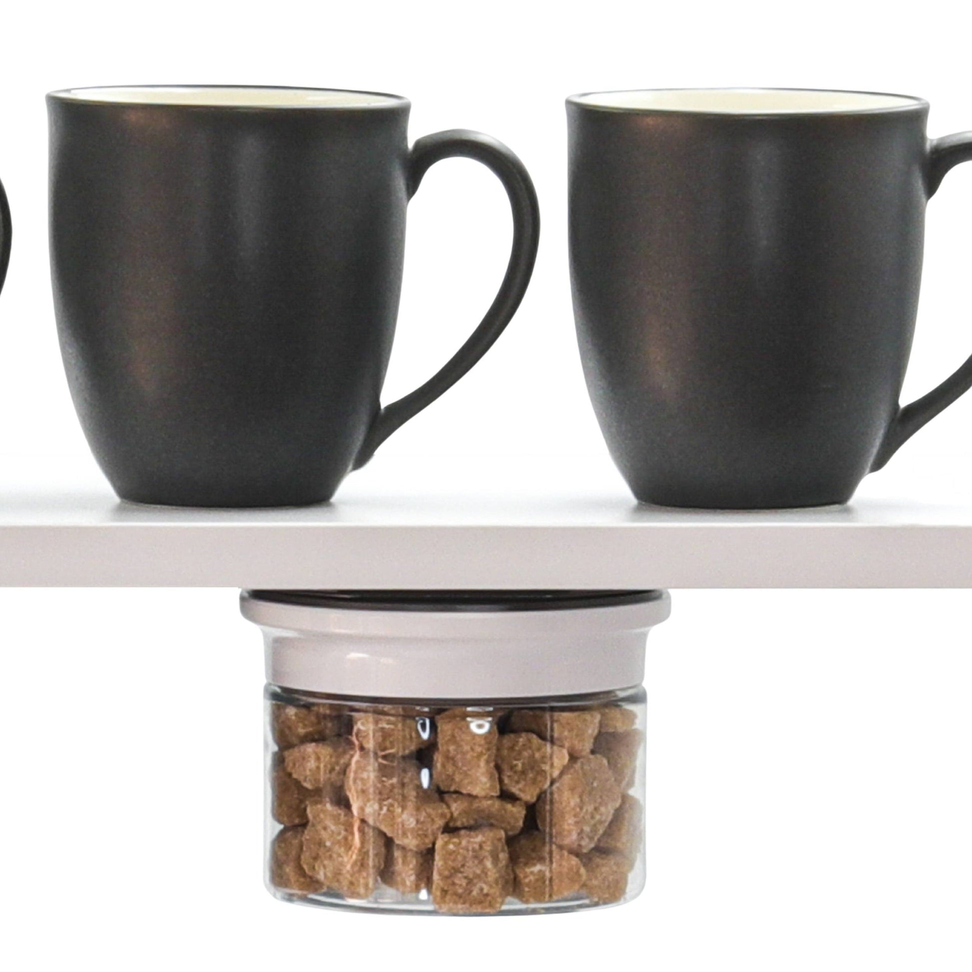 Kitchen Organizer Stash Jar filled with sugar cubes mounted under shelf, optimizing space above coffee mugs.