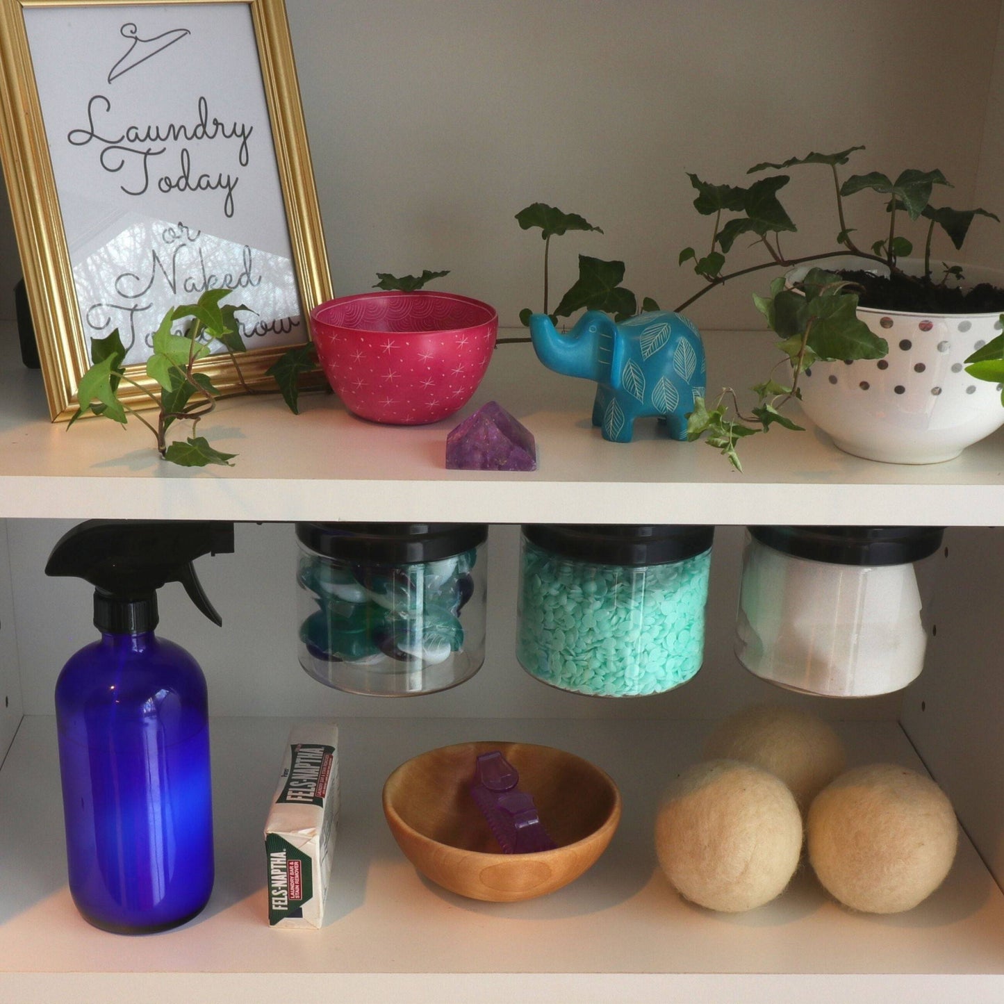 Organized laundry shelf featuring Laundry Room Storage Jars - Space Saving Canisters for storing laundry supplies like pods, beads, and dryer balls.