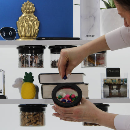 User selecting candy from a stash jar under a shelf, highlighting fast-access magnetic storage for kitchen or office use.