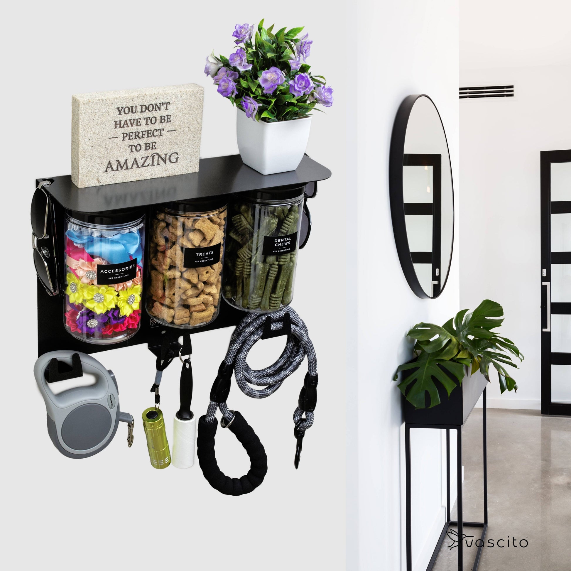 Modern black dog leash holder with treat jars and hooks mounted near entryway, ideal for stylish pet supply organization.