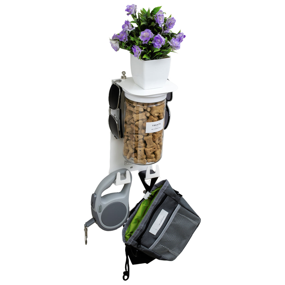 Dog Leash Holder for Wall with 4.75" shelf in Designer White featuring airtight treat jar, hooks for gear, and a decorative flower pot on top.