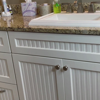 Closed bathroom vanity with under sink storage system hidden inside. Sleek design for modern bathroom organization.