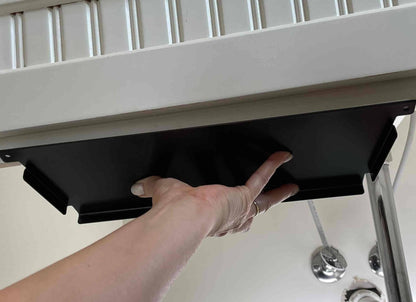 Hand installing under sink organizer bracket for Laundry Containers Organizer, designed for secure, space-saving jar storage in laundry rooms.
